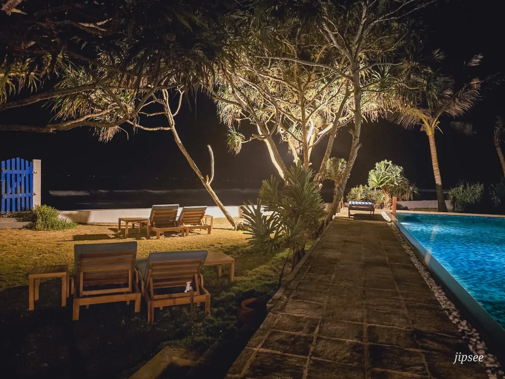 transat sur l'herbe et piscine eclairée la nuit