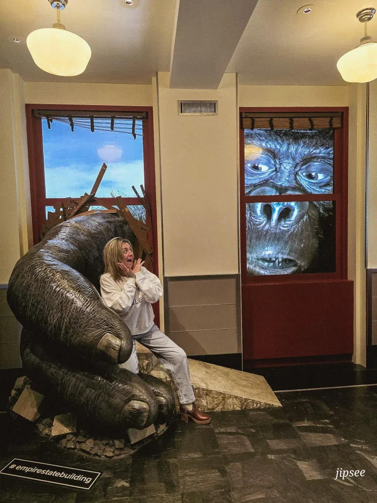 femme effrayée devant une caricature de gorille a travers une fenetre