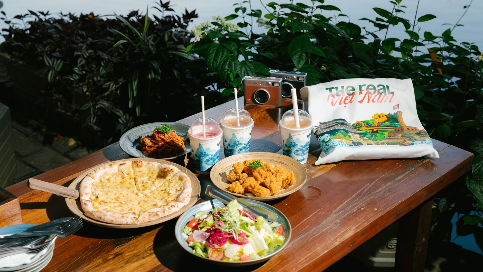 Enjoy a vibrant meal by the river in Ninh Bình, featuring a mix of Western and Asian dishes.